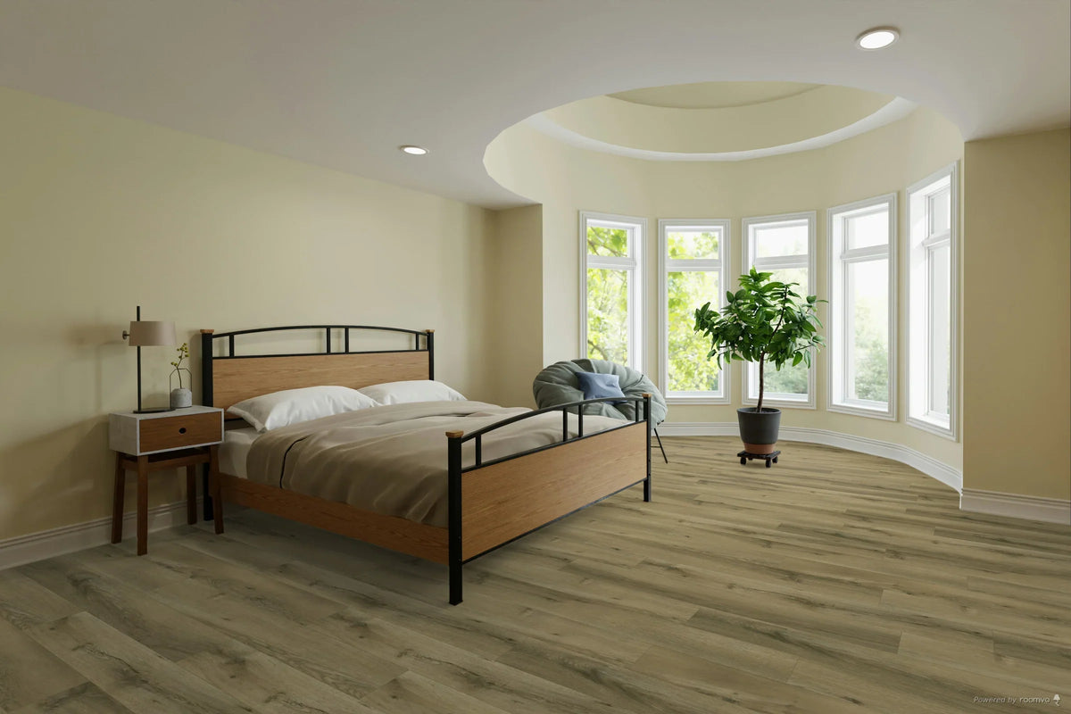 A modern bedroom featuring light gray wood-look plank flooring, beige walls, a wooden and black metal bed frame, a matching nightstand, and a large potted plant near a curved bay window.