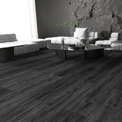 Black Ash SPC flooring in a modern living room with realistic dark oak wood grain planks, waterproof luxury vinyl flooring, contemporary black and grey interior design, feature wall and premium residential décor.