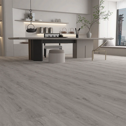 Modern kitchen featuring Gran Canaria Luxury Click Vinyl Flooring 5mm with mid-grey oak-effect SPC rigid core flooring, authentic wood grain texture, embossed matt finish, waterproof click vinyl planks and contemporary open-plan interior.
