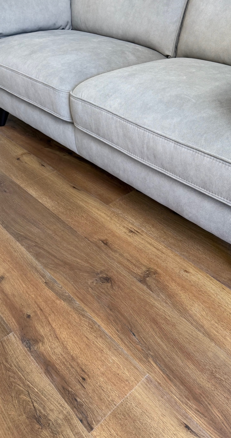 Real customer installation of Hawkshead Oak luxury click vinyl flooring in a modern living room, showcasing authentic oak wood grain, rich natural tones and realistic plank detail. Waterproof, scratch-resistant SPC flooring ideal for busy family homes, pets and everyday living.