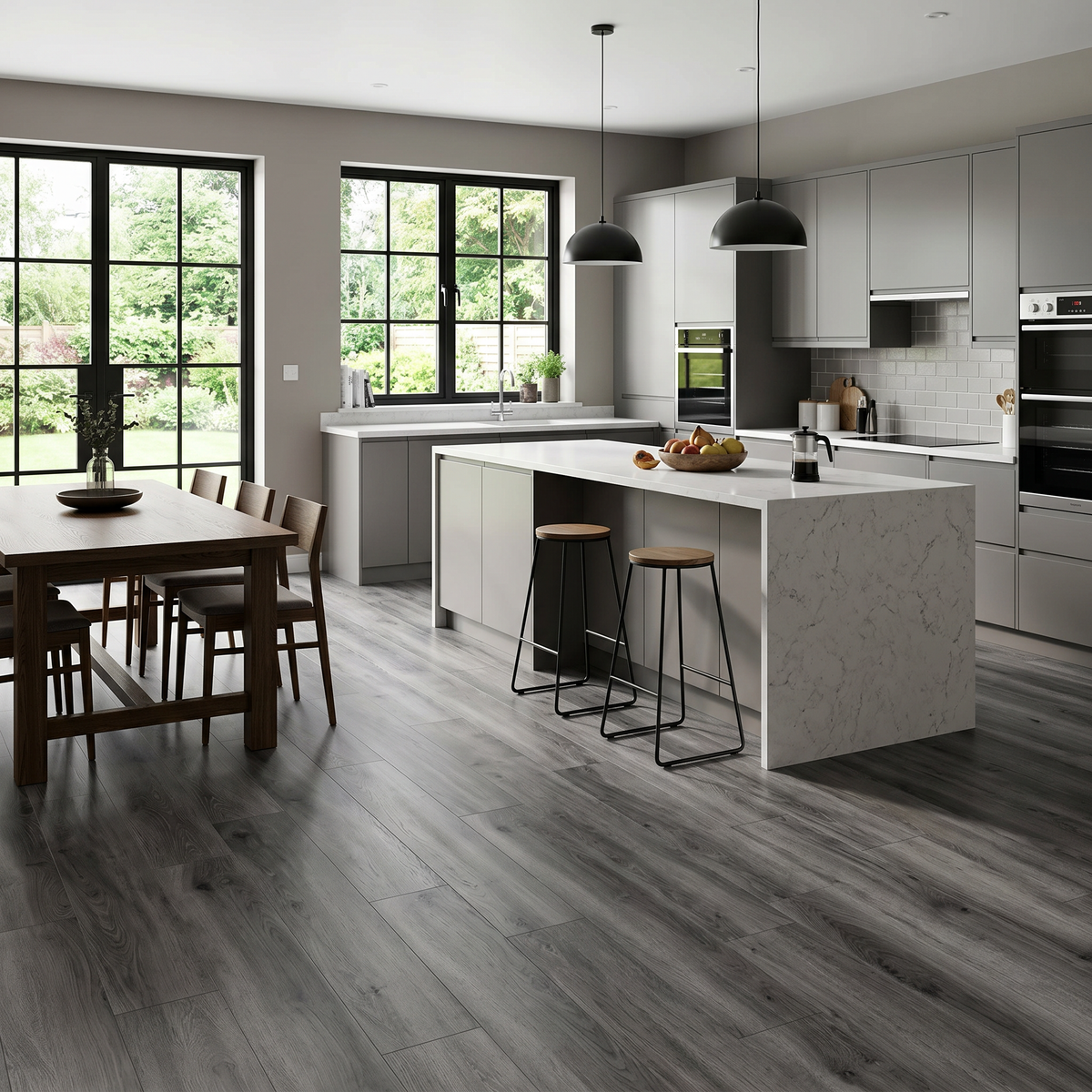 Honister Slate Grey Luxury Click Vinyl Flooring 5mm installed throughout a modern open-plan kitchen and dining area, showcasing dark slate grey wood-effect SPC planks with authentic grain, realistic knot detailing and a durable matt finish, ideal for waterproof family homes.