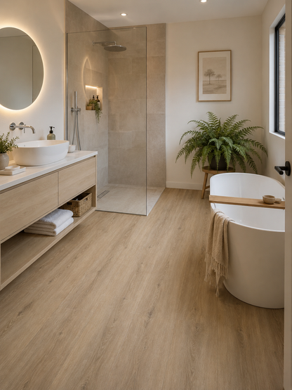 Amazon Oak luxury click vinyl flooring in a modern bathroom with wood effect plank flooring, freestanding bath, walk-in shower, floating vanity unit and neutral spa-inspired décor.