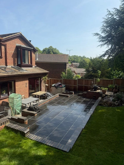 Fantasy black slate effect outdoor porcelain paving room setting