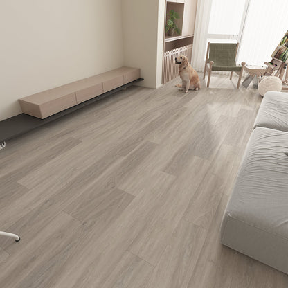 Modern open-plan living room featuring Epping Teak Grey luxury click vinyl flooring with cool grey wood-effect planks, realistic grain detailing and embossed matt finish. This waterproof SPC flooring creates a bright, contemporary space with seamless wide plank flooring, perfect for modern family homes.